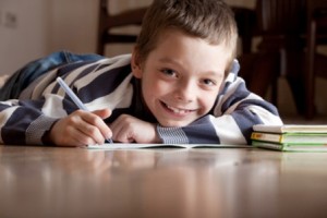 Child does lessons lying on the floor